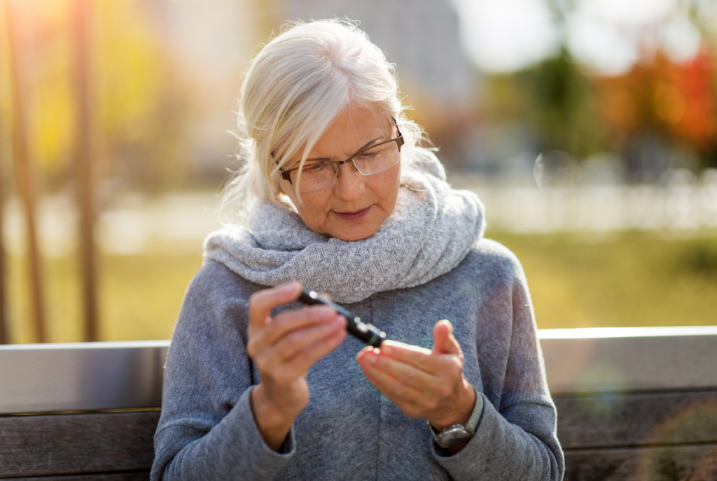 old woman taking her blood sugar