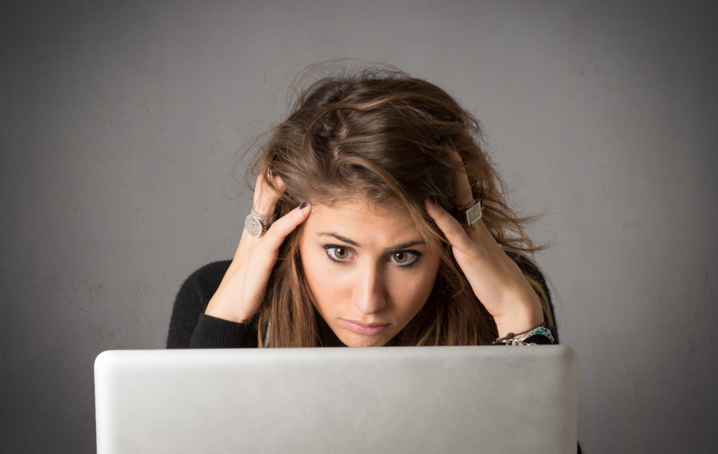 woman staring at computer, stressed and frazzled