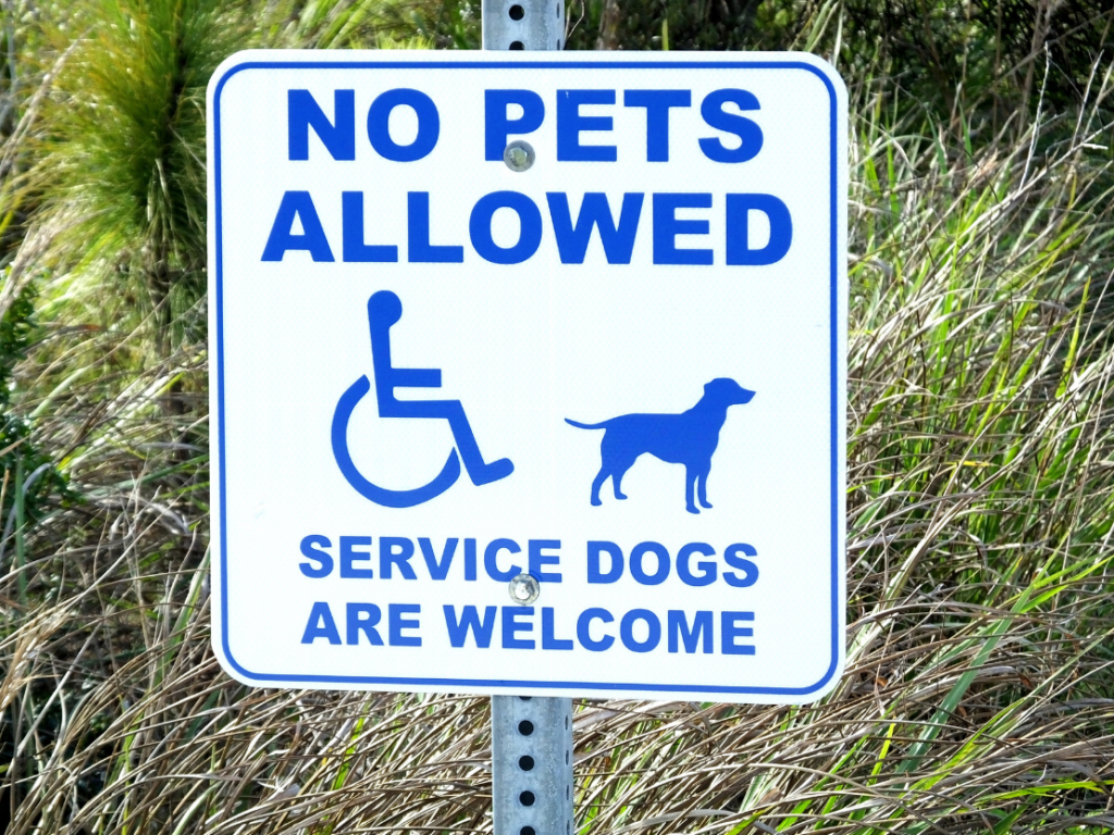 Street sign bearing the words "no pets allowed. Service dogs are welcome."