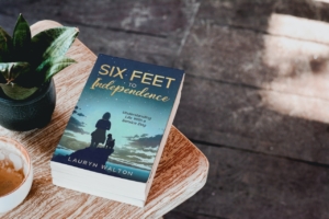 The book Six Feet to Independence sitting on the corner of a table