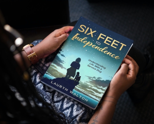 The book Six Feet to Independence in the hands of an African American woman