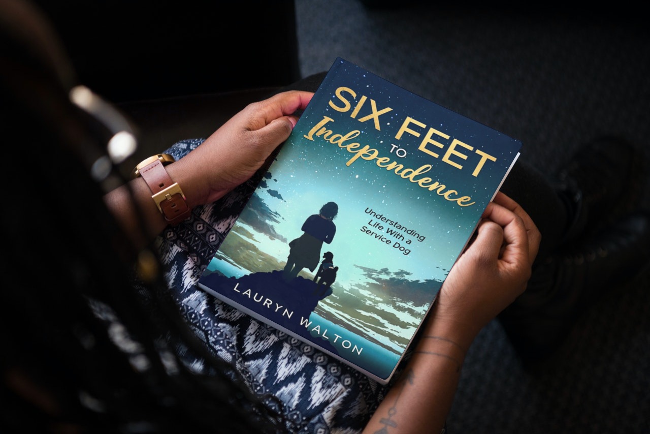 The book Six Feet to Independence in the hands of an African American woman
